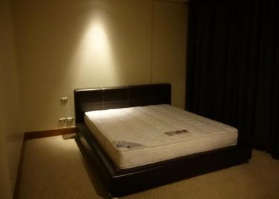 Dimly lit bedroom with a large bed