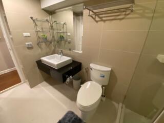 Modern bathroom with glass shower enclosure and sleek vanity