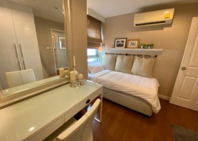 Cozy bedroom with wooden flooring and modern amenities