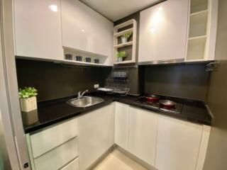 Modern kitchen with white cabinets and stainless steel appliances