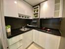 Modern kitchen with white cabinets and stainless steel appliances