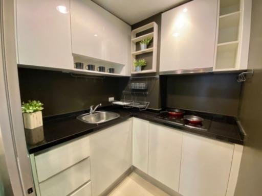 Modern kitchen with white cabinets and stainless steel appliances