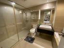 Modern bathroom interior with glass shower enclosure, beige tiles, and contemporary fixtures