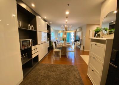 Open floor plan with modern kitchen leading to a well-lit dining and living area