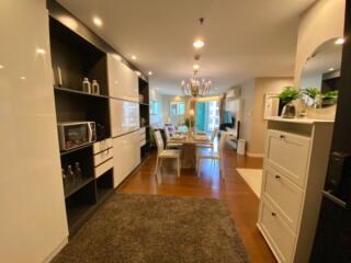 Open floor plan with modern kitchen leading to a well-lit dining and living area