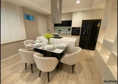 Modern kitchen with dining area featuring elegant furniture and state-of-the-art appliances
