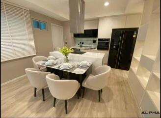 Modern kitchen with dining area featuring elegant furniture and state-of-the-art appliances