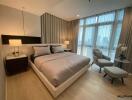 Modern bedroom with large window and comfortable furnishings