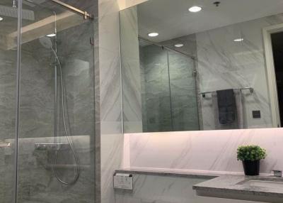 Modern bathroom interior with a shower and granite walls