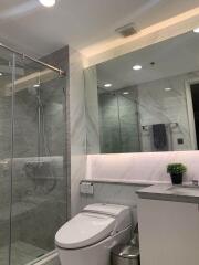 Modern bathroom interior with a shower and granite walls