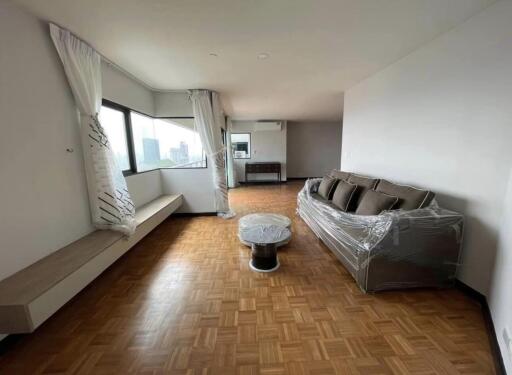 Spacious and bright living room with hardwood flooring and city view