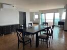 Spacious living room with a dining table and natural light