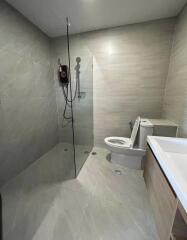 Modern bathroom with walk-in shower and neutral tiles