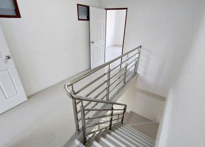 Modern staircase with stainless steel handrails in a residential building