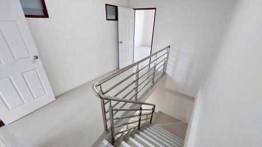 Modern staircase with stainless steel handrails in a residential building