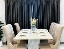 Elegant dining area with a marble table and upholstered chairs