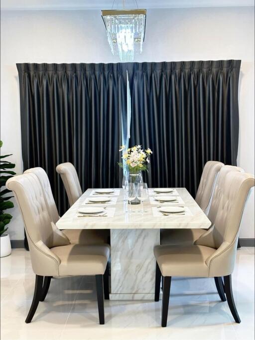 Elegant dining area with a marble table and upholstered chairs