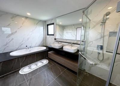 Modern bathroom with double vanity and glass-enclosed shower