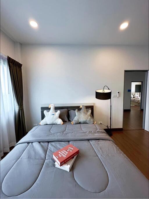 Modern bedroom with neatly made bed, ambient lighting and a contemporary style