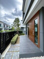 Modern house facade with dark storm clouds