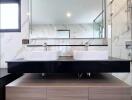 Modern bathroom with dual sinks and marble tiling