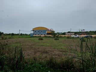 Two-story suburban house seen from across an open field