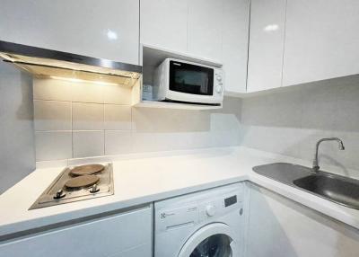 Modern compact kitchen with white appliances