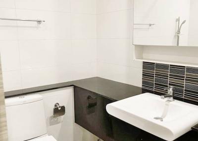 Modern white tiled bathroom with sleek fixtures