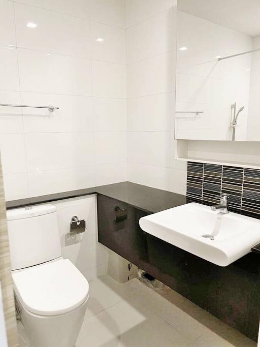 Modern white tiled bathroom with sleek fixtures