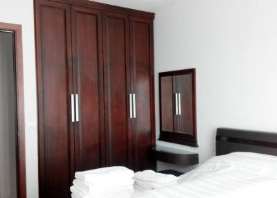 Modern bedroom with dark wood furniture and white bedding