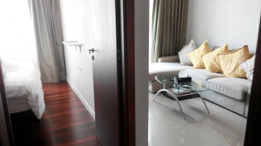 Modern Bedroom with Golden Accent Pillows and Glass Side Table