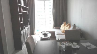 Modern living room with ample natural light and comfortable seating