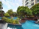 Luxurious outdoor swimming pool area with lush greenery in a residential building