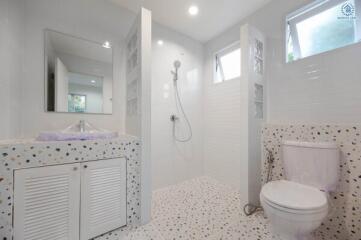 Modern bathroom with white interior design and terrazzo flooring
