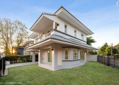 Elegant two-story house with a spacious front yard at twilight