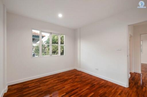 Spacious Bedroom with Polished Hardwood Floors and Ample Natural Light