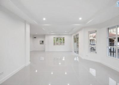 Spacious and Bright Unfurnished Living Room with Large Windows and Glossy Floor Tiles