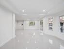 Spacious and Bright Unfurnished Living Room with Large Windows and Glossy Floor Tiles