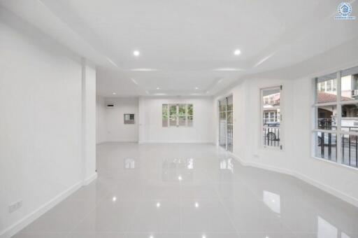 Spacious and Bright Unfurnished Living Room with Large Windows and Glossy Floor Tiles