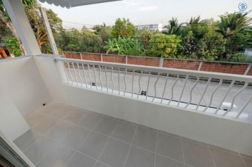 Cozy balcony with a view of greenery and protective railing