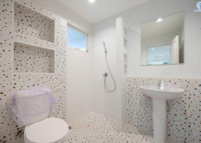Modern bathroom with terrazzo tiles and white fixtures