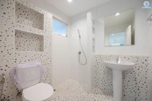 Modern bathroom with terrazzo tiles and white fixtures