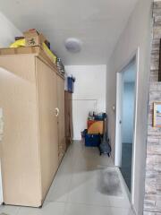 Narrow hallway with storage cabinets and tiled flooring