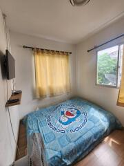 Cozy bedroom with a large window and natural light