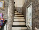 A narrow staircase with stone-patterned wallpaper