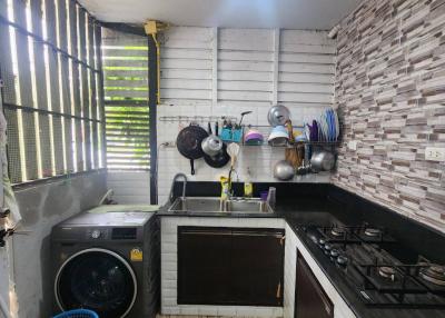 Compact kitchen space with modern appliances and wooden flooring