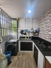 Compact kitchen space with modern appliances and wooden flooring