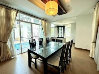 Bright dining room with large table and pool view