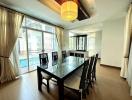 Bright dining room with large table and pool view
