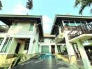 Modern two-story house with a balcony and a swimming pool